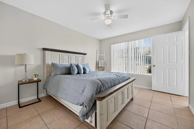 a bathroom with a granite countertop toilet sink and mirror