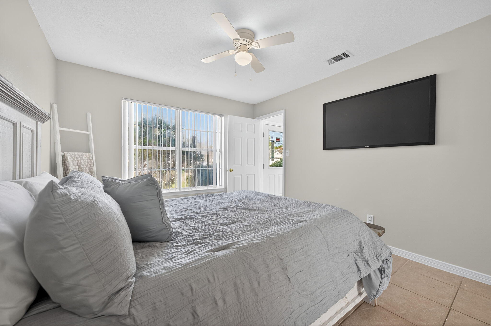 150 Beach Drive Fort Walton Beach, FL 32547 - Photo 26 of 56 a spacious bedroom with a bed and a flat screen tv