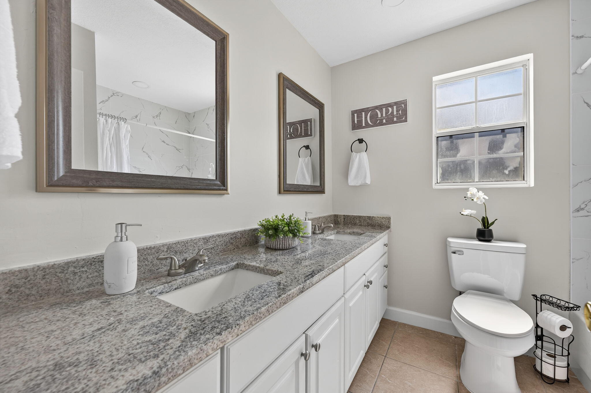 150 Beach Drive Fort Walton Beach, FL 32547 - Photo 27 of 56 a bathroom with a granite countertop toilet sink and mirror