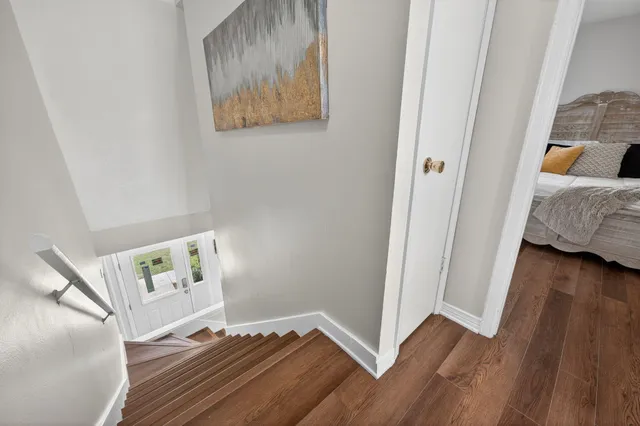 a bedroom with a bed and a painting on the wall