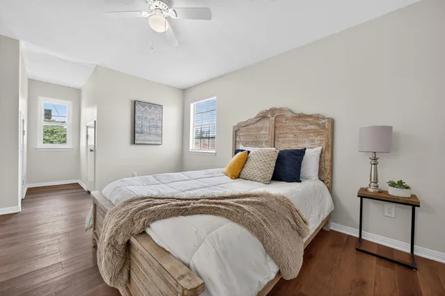 a bedroom with a bed and wooden floor