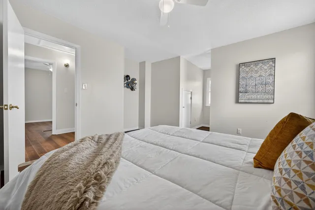 a bedroom with a bed and wooden floor