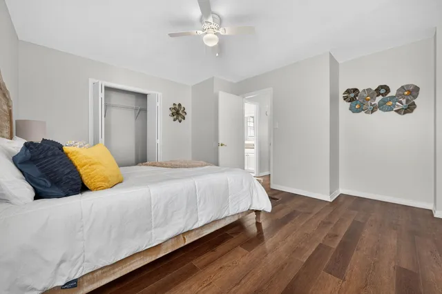 a bathroom with a granite countertop toilet sink and mirror