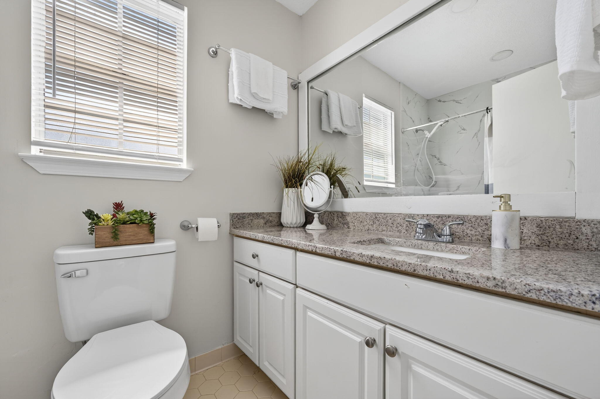 150 Beach Drive Fort Walton Beach, FL 32547 - Photo 37 of 56 a bathroom with a granite countertop toilet sink and mirror