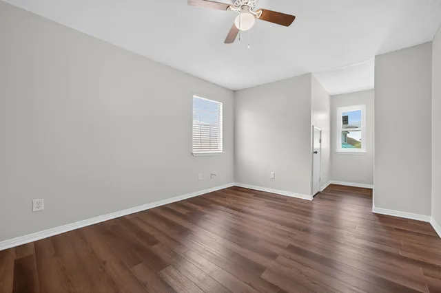 an empty room with wooden floor and closet