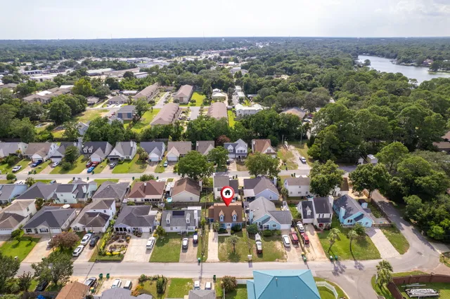 an aerial view of a city with lots of residential buildings ocean and mountain view