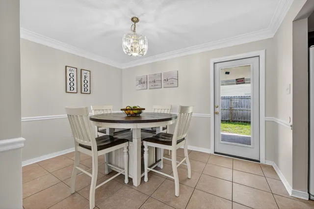 a view of a dining room with furniture and chandelier