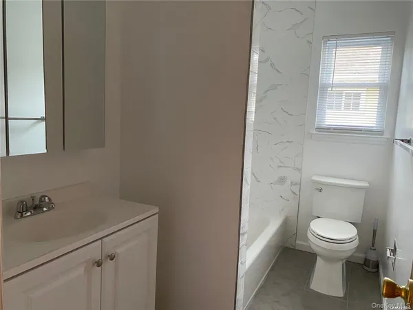 a white toilet sitting next to a bathroom sink
