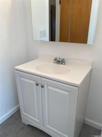 a bathroom with a sink and vanity