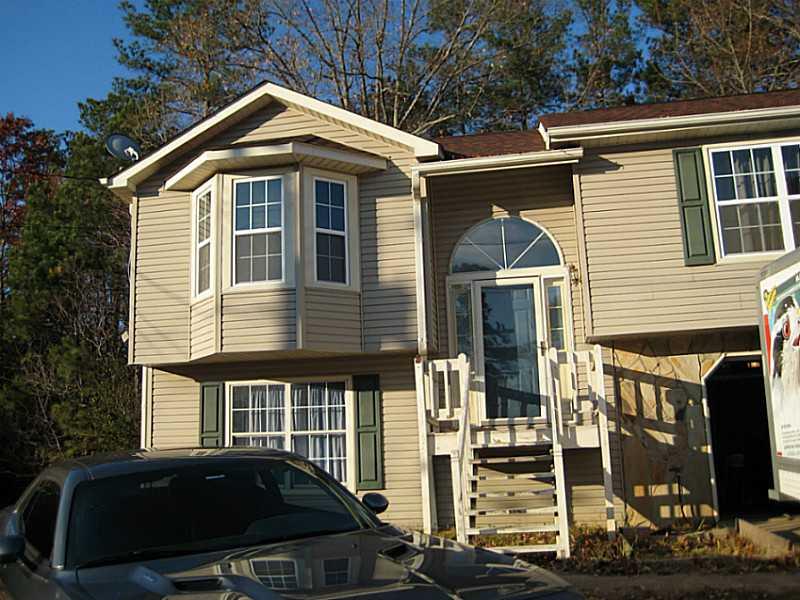 a front view of a house with parking space