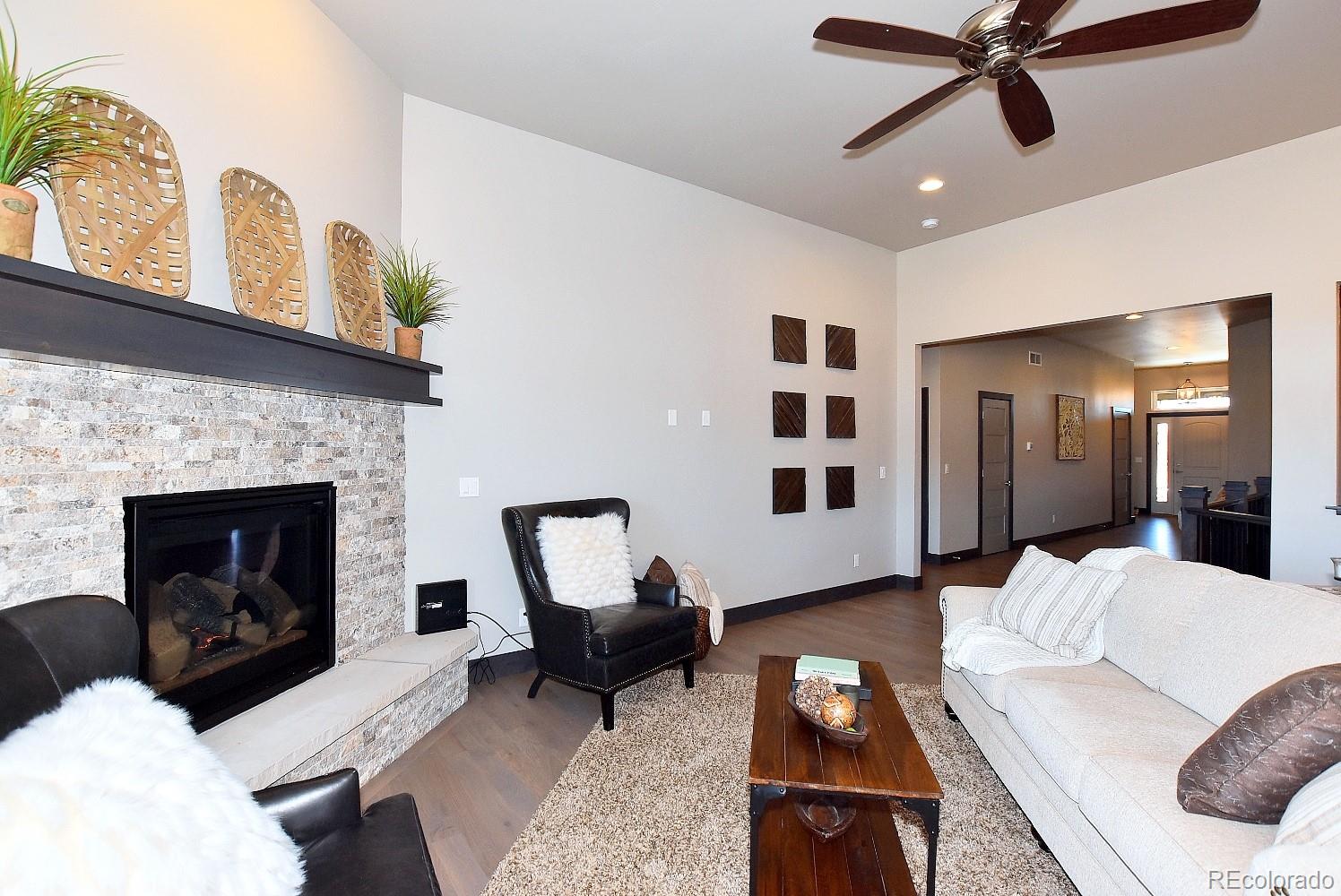4792 Mariana Ridge Court Loveland, CO 80537 - Photo 12 of 39 a living room with furniture and a fireplace