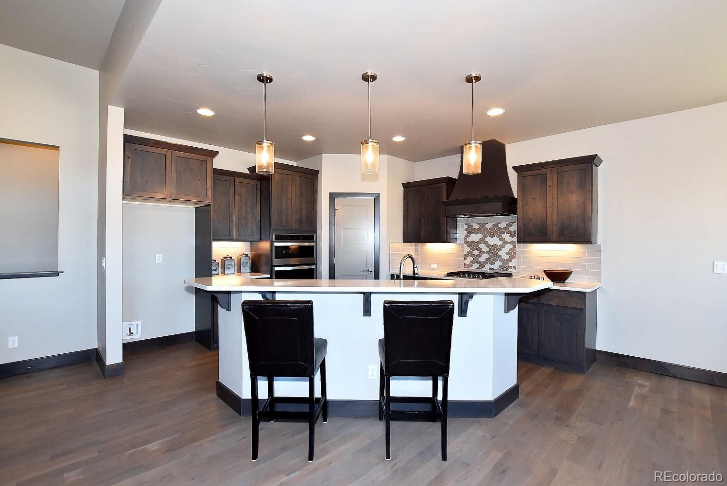4792 Mariana Ridge Court Loveland, CO 80537 - Photo 14 of 39 a kitchen with a sink cabinets and wooden floor