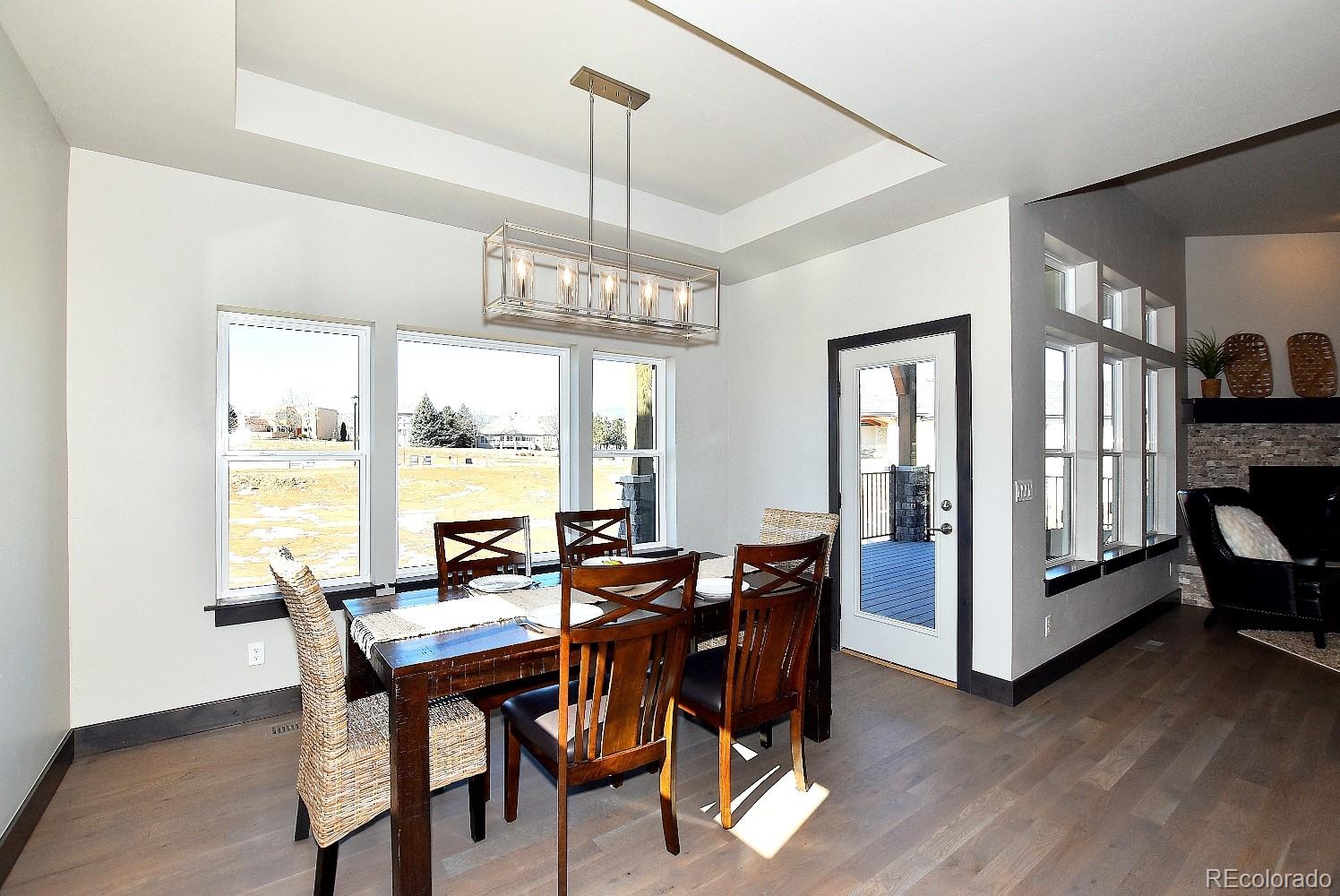 4792 Mariana Ridge Court Loveland, CO 80537 - Photo 18 of 39 a view of a dining room with furniture window and wooden floor