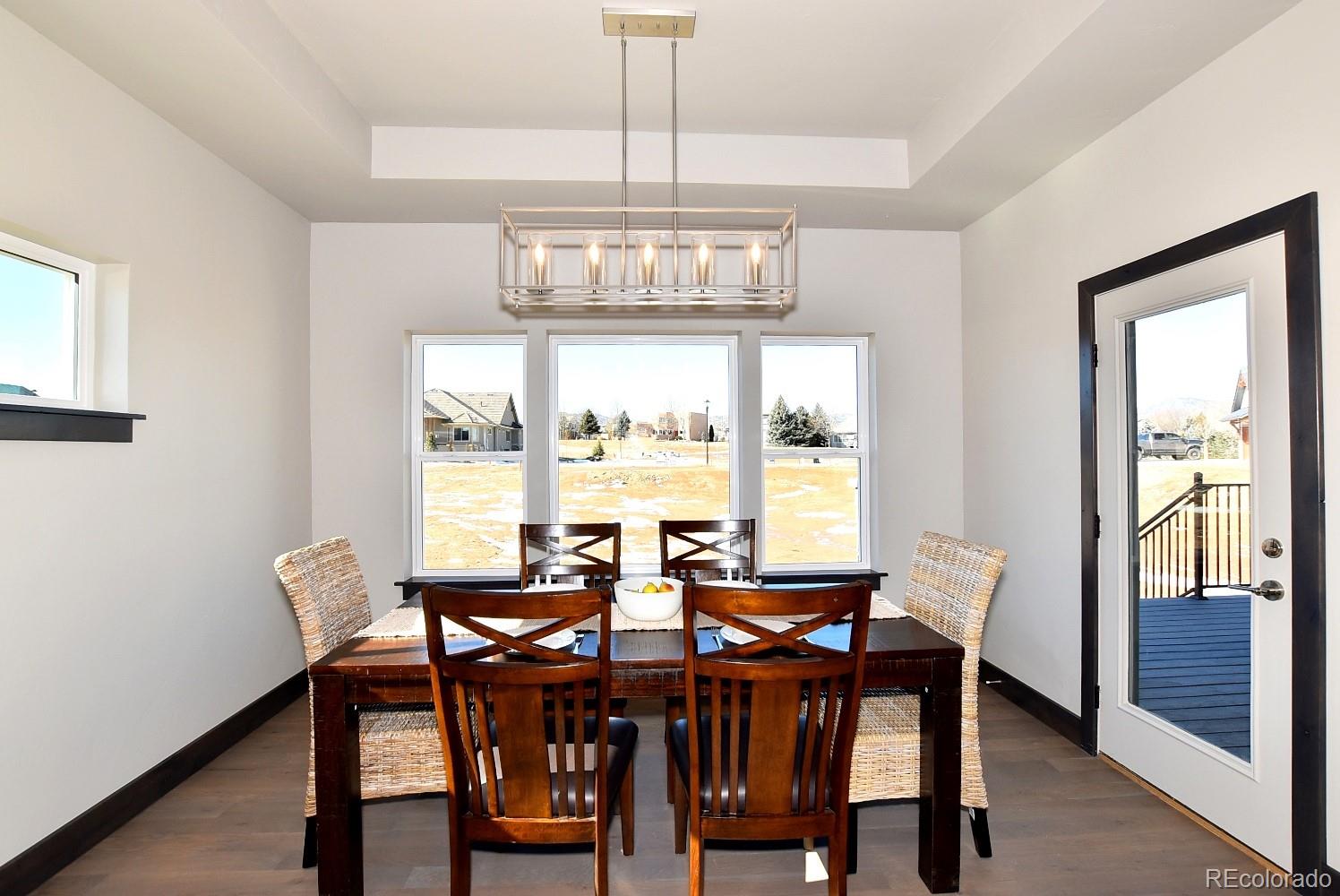 4792 Mariana Ridge Court Loveland, CO 80537 - Photo 19 of 39 a view of a dining room with furniture window and outside view