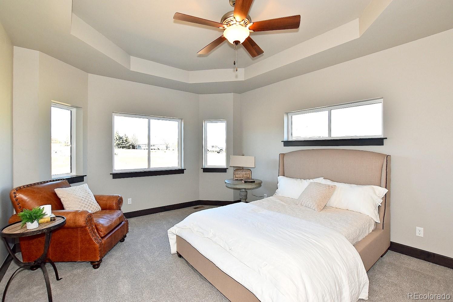 4792 Mariana Ridge Court Loveland, CO 80537 - Photo 20 of 39 a bedroom with a bed and window