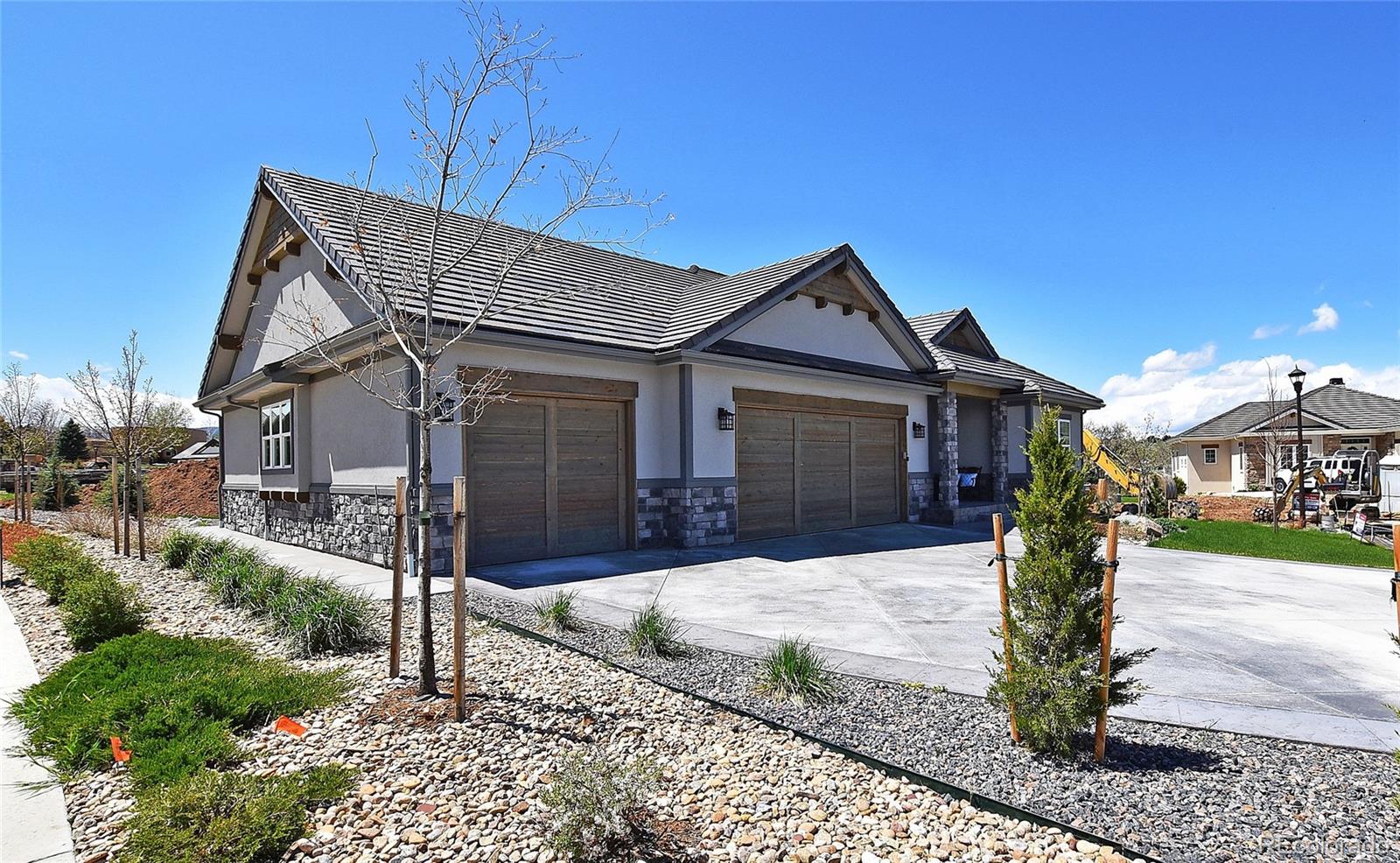 4792 Mariana Ridge Court Loveland, CO 80537 - Photo 2 of 39 a front view of a house with a yard and potted plants