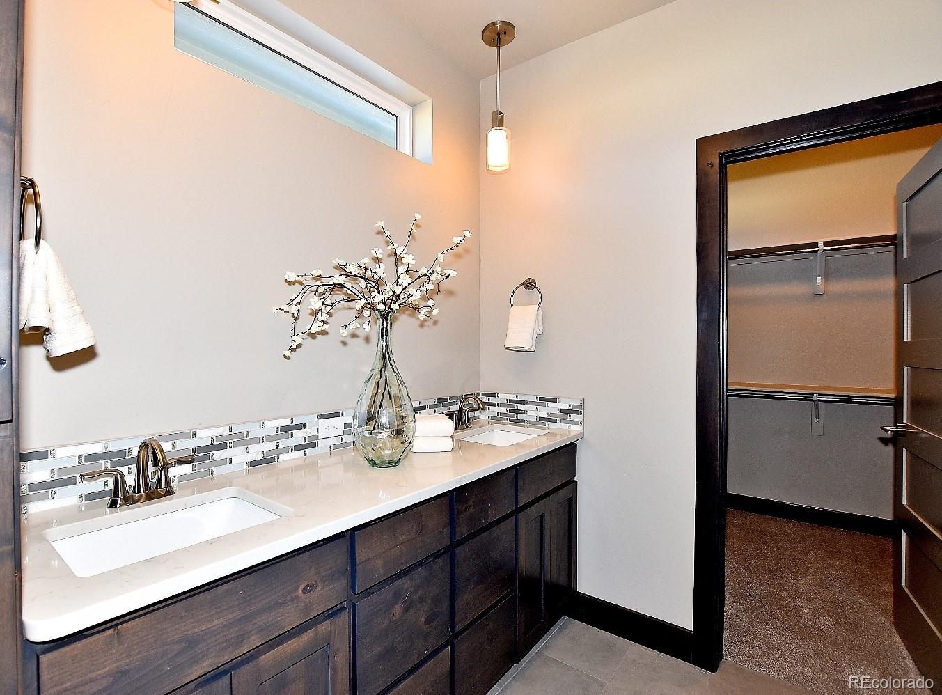 4792 Mariana Ridge Court Loveland, CO 80537 - Photo 24 of 39 a bathroom with a sink and a mirror