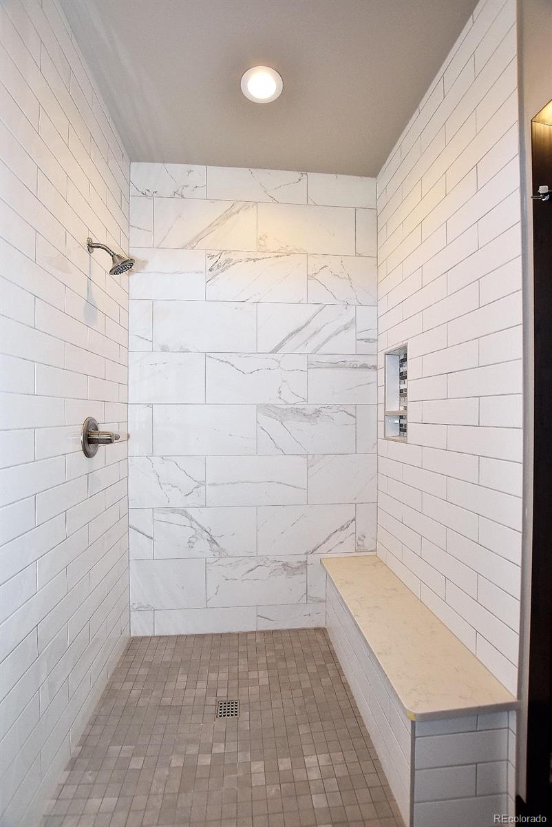 4792 Mariana Ridge Court Loveland, CO 80537 - Photo 25 of 39 a bathroom with a bathtub and shower