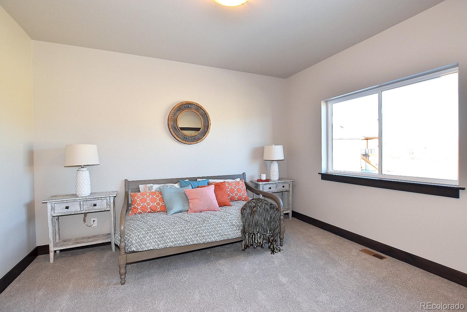 4792 Mariana Ridge Court Loveland, CO 80537 - Photo 28 of 39 a bedroom with a bed and a window