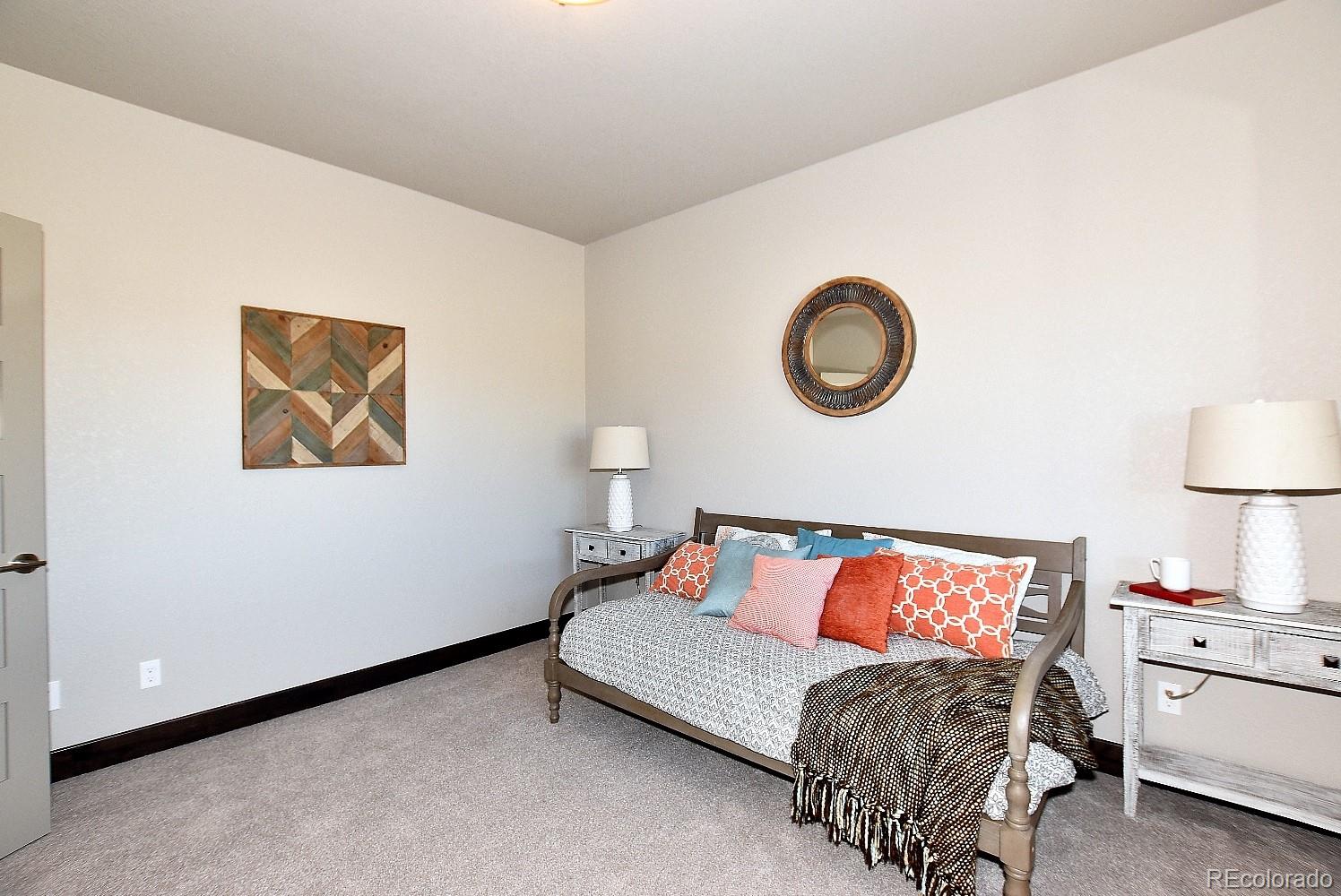 4792 Mariana Ridge Court Loveland, CO 80537 - Photo 30 of 39 a bedroom with a bed and a couch