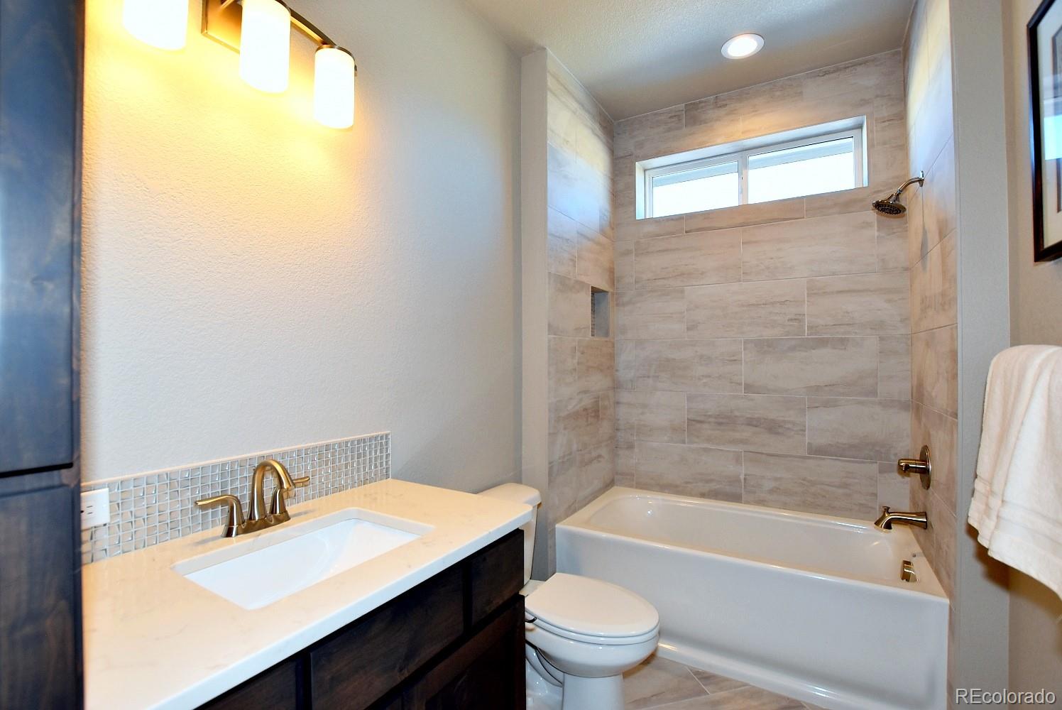 4792 Mariana Ridge Court Loveland, CO 80537 - Photo 31 of 39 a bathroom with a sink and a mirror