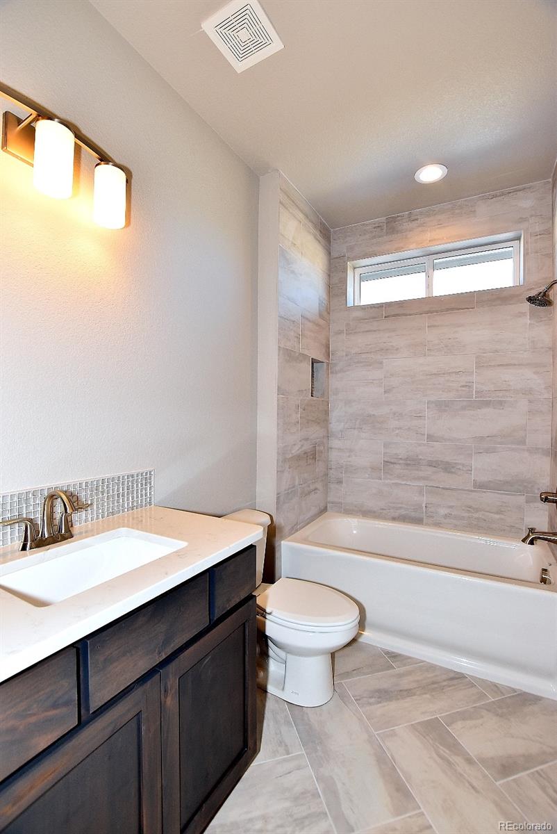 4792 Mariana Ridge Court Loveland, CO 80537 - Photo 32 of 39 a bathroom with a sink a toilet and shower