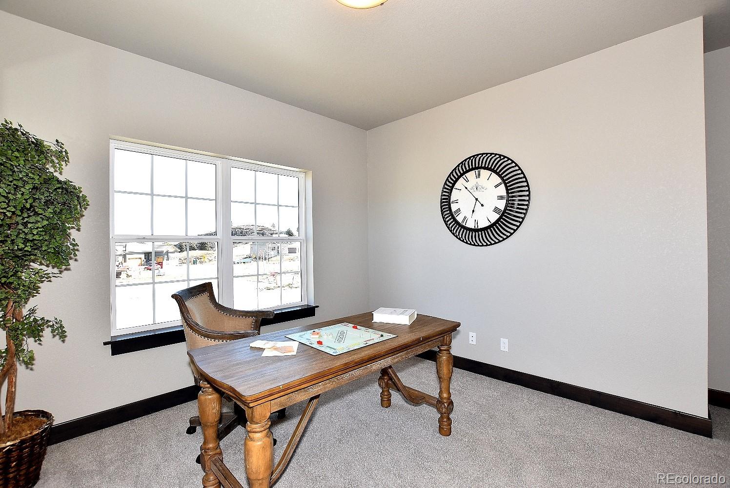 4792 Mariana Ridge Court Loveland, CO 80537 - Photo 35 of 39 a view of a room with a table and chairs