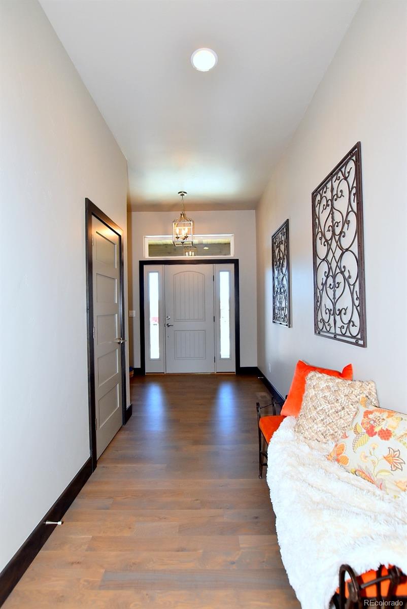 4792 Mariana Ridge Court Loveland, CO 80537 - Photo 6 of 39 a view of a hallway with wooden floor and workspace