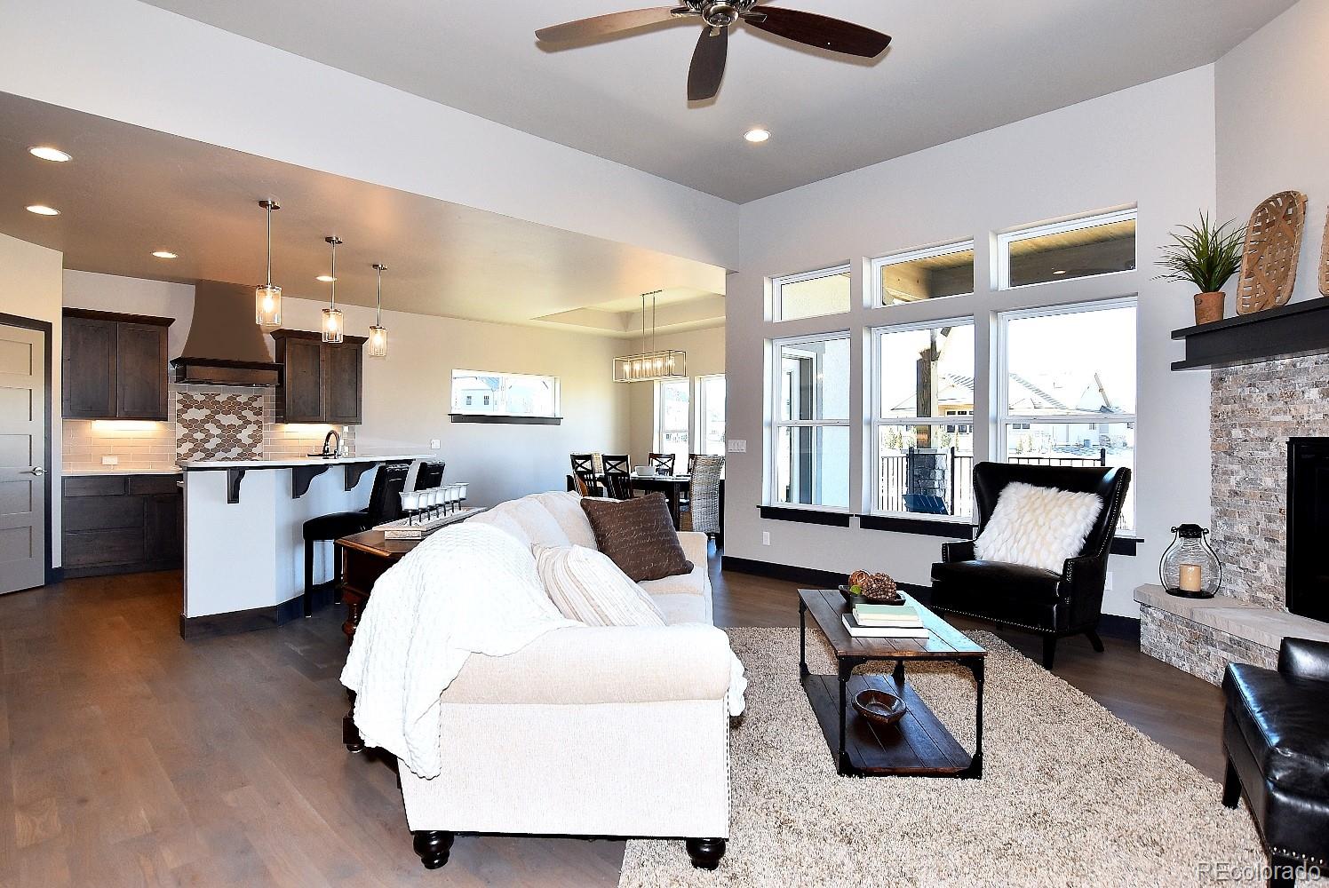 4792 Mariana Ridge Court Loveland, CO 80537 - Photo 7 of 39 a living room with furniture kitchen view and a large window