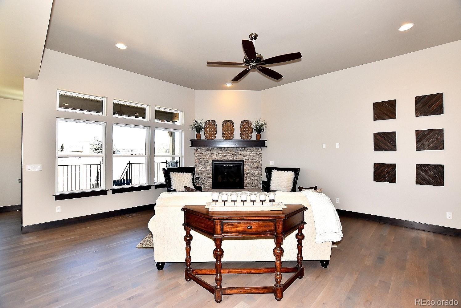 4792 Mariana Ridge Court Loveland, CO 80537 - Photo 9 of 39 a living room with a couch a dining table and a fireplace