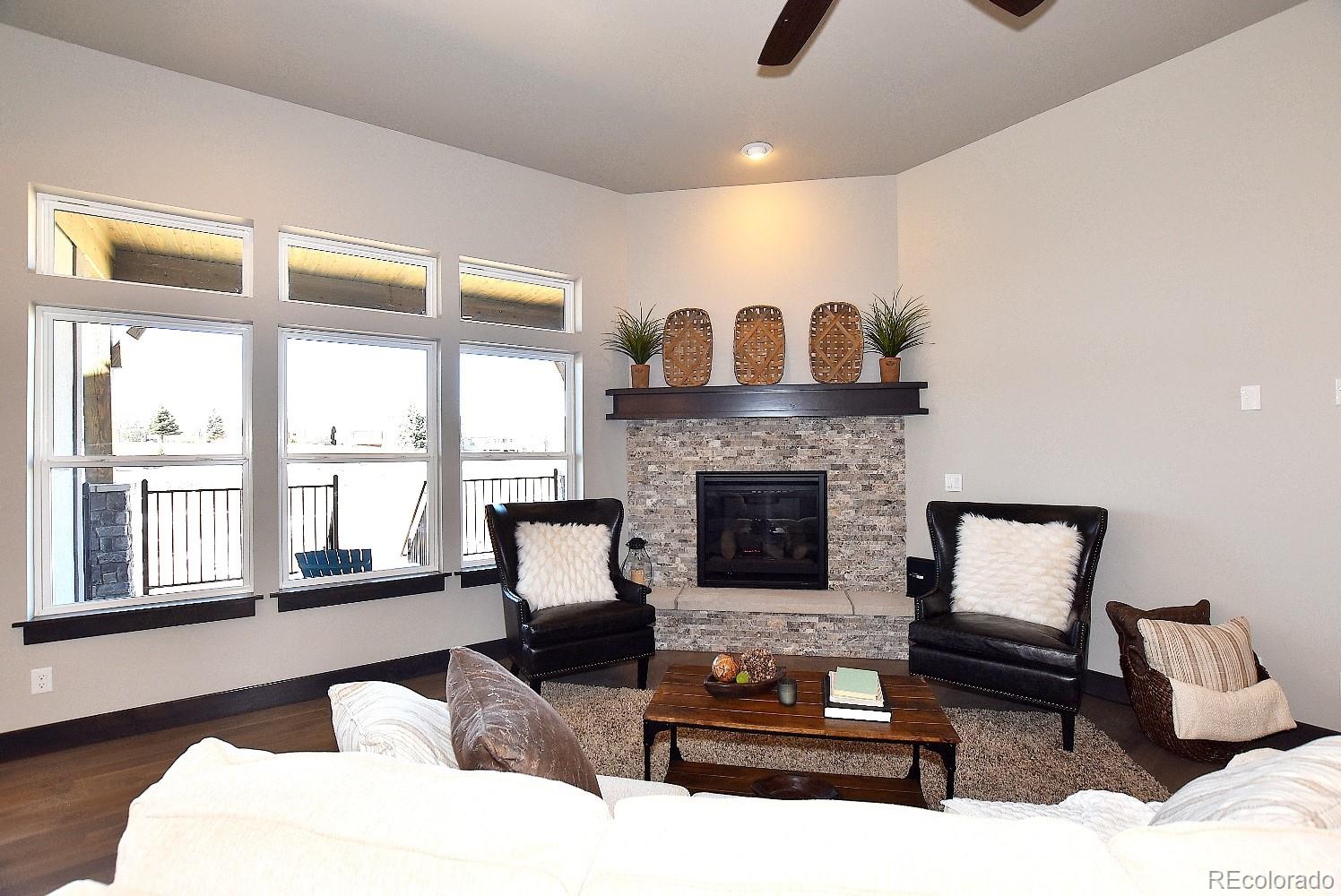 4792 Mariana Ridge Court Loveland, CO 80537 - Photo 10 of 39 a living room with furniture and a fireplace