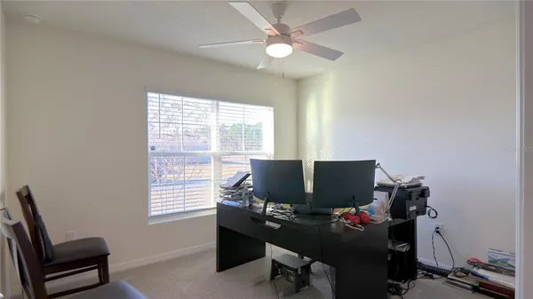 a kitchen with stainless steel appliances a refrigerator a stove a sink and chairs