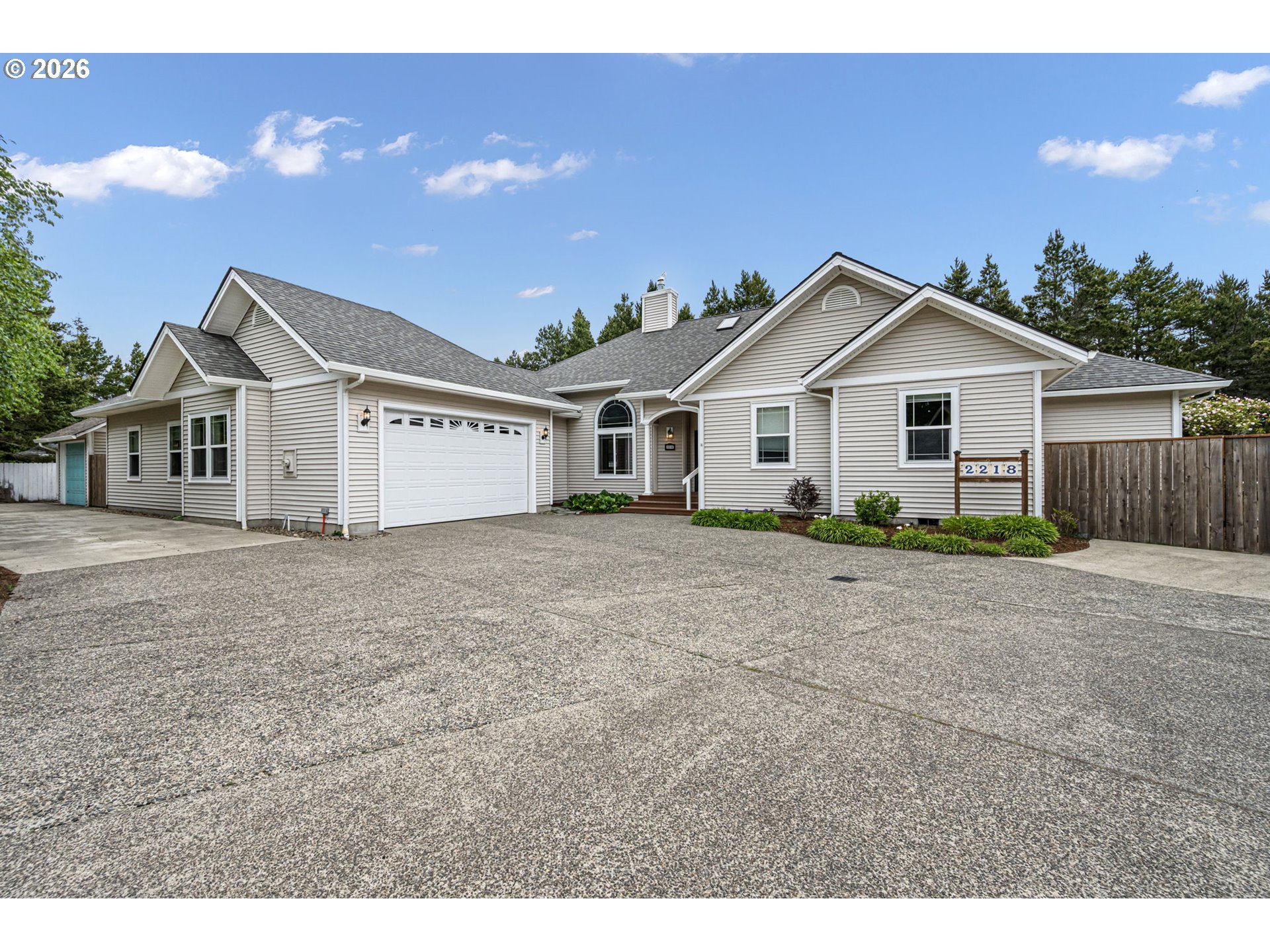 2218 Willow Loop Florence, OR 97439 - Photo 15 of 47 a front view of a house with a garden and yard