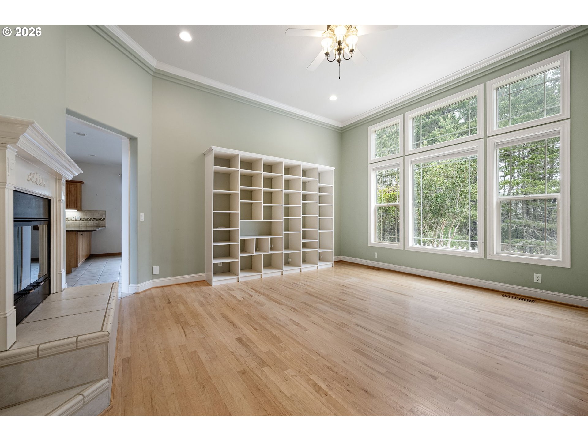 2218 Willow Loop Florence, OR 97439 - Photo 5 of 47 a view of an empty room with a window and wooden floor