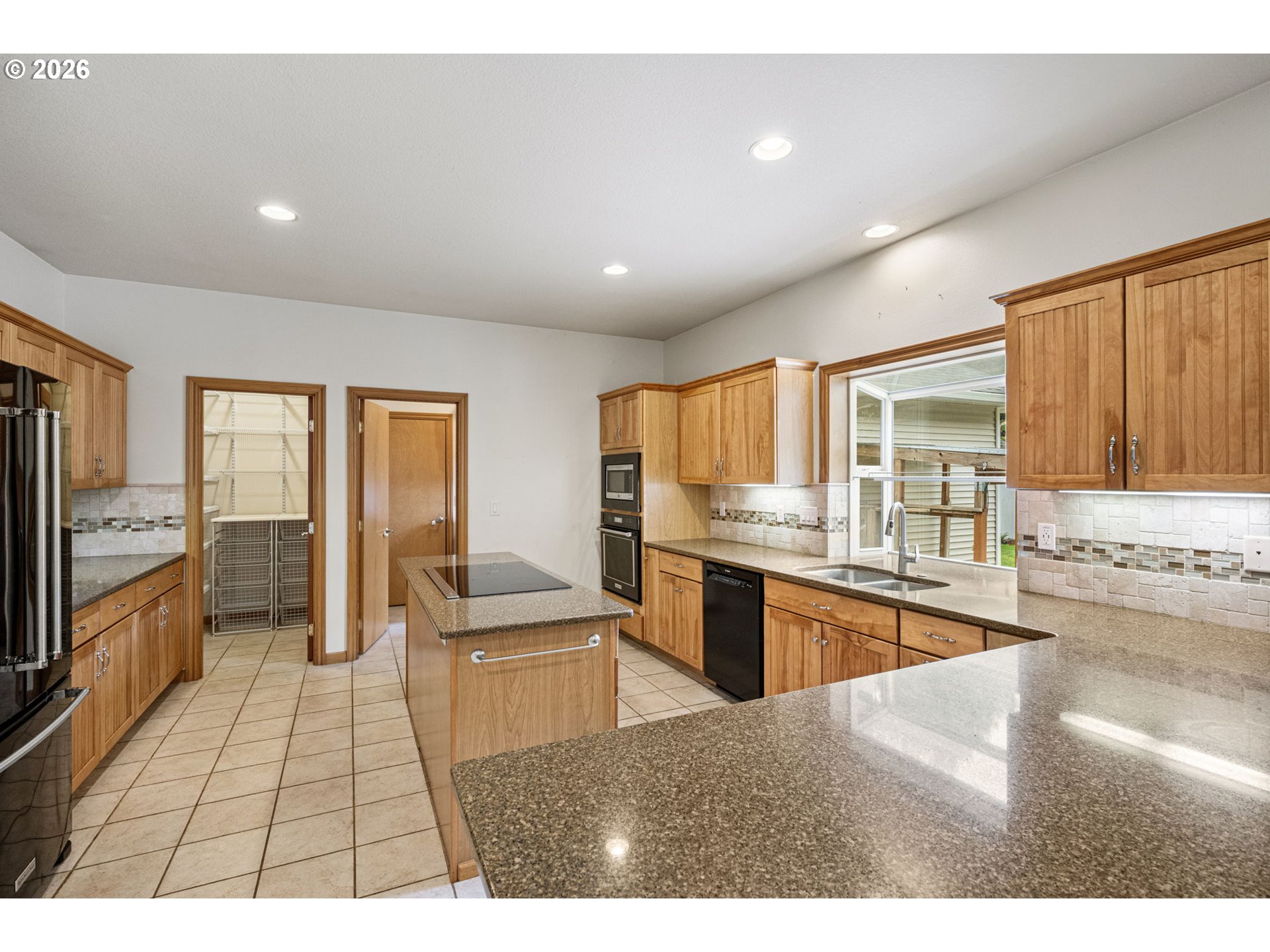 2218 Willow Loop Florence, OR 97439 - Photo 7 of 47 a open kitchen with granite countertop a sink stove top oven and refrigerator