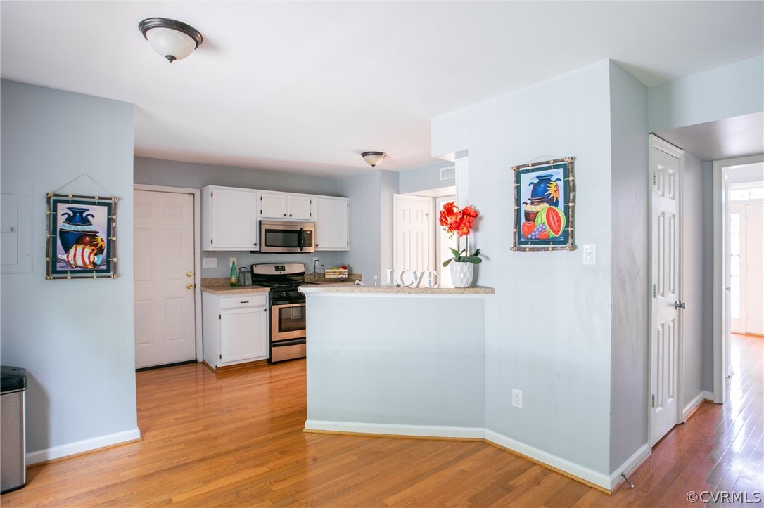3248 Ransom Hills Road Richmond, VA 23237 - Photo 13 of 28 a kitchen with a refrigerator and a stove top oven