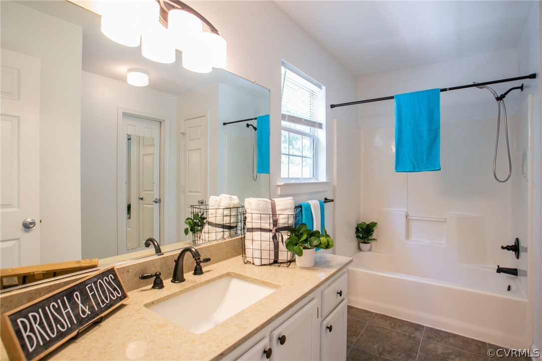 3248 Ransom Hills Road Richmond, VA 23237 - Photo 20 of 28 a bathroom with a granite countertop sink and a bathtub