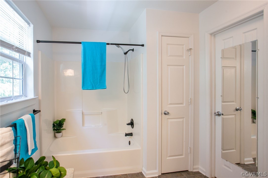 3248 Ransom Hills Road Richmond, VA 23237 - Photo 22 of 28 a bathroom with a bathtub and a shower