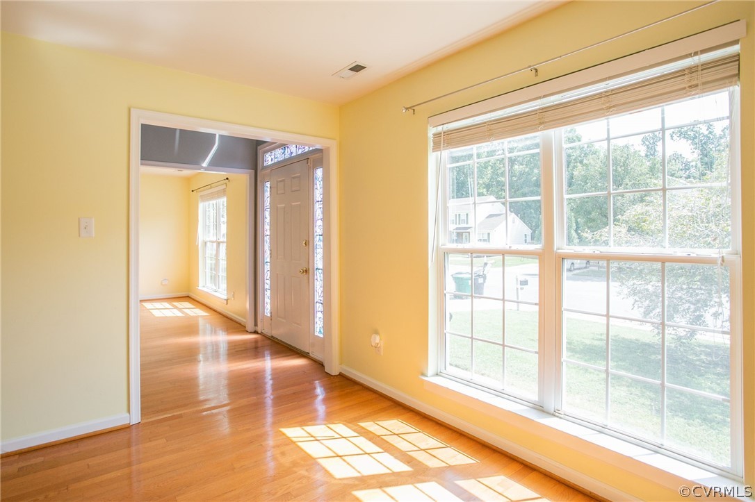 3248 Ransom Hills Road Richmond, VA 23237 - Photo 5 of 28 a view of an empty room with wooden floor and a window