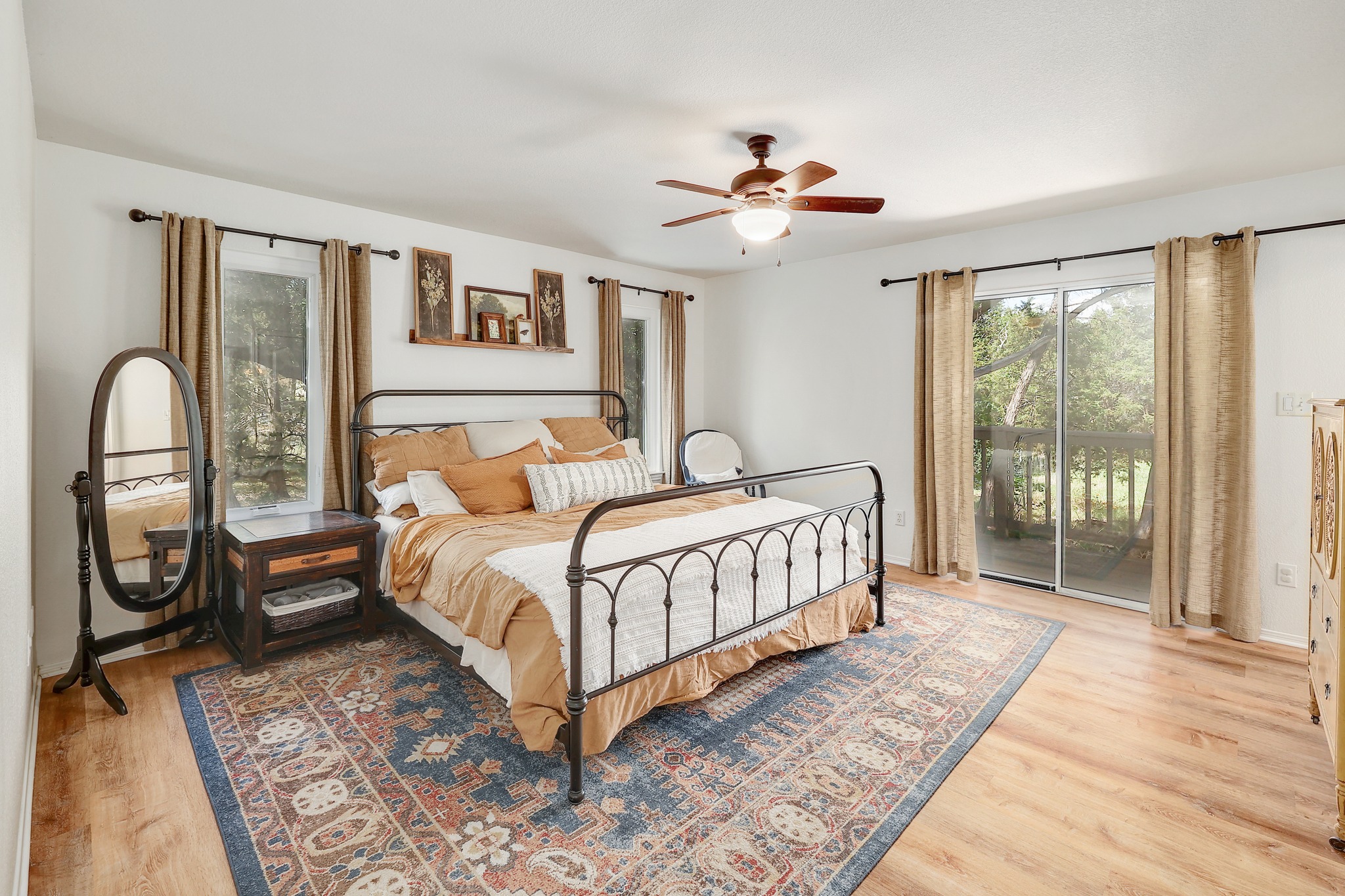 1455 County Road 262 Georgetown, TX 78633 - Photo 14 of 40 a bedroom with a large bed and a chandelier