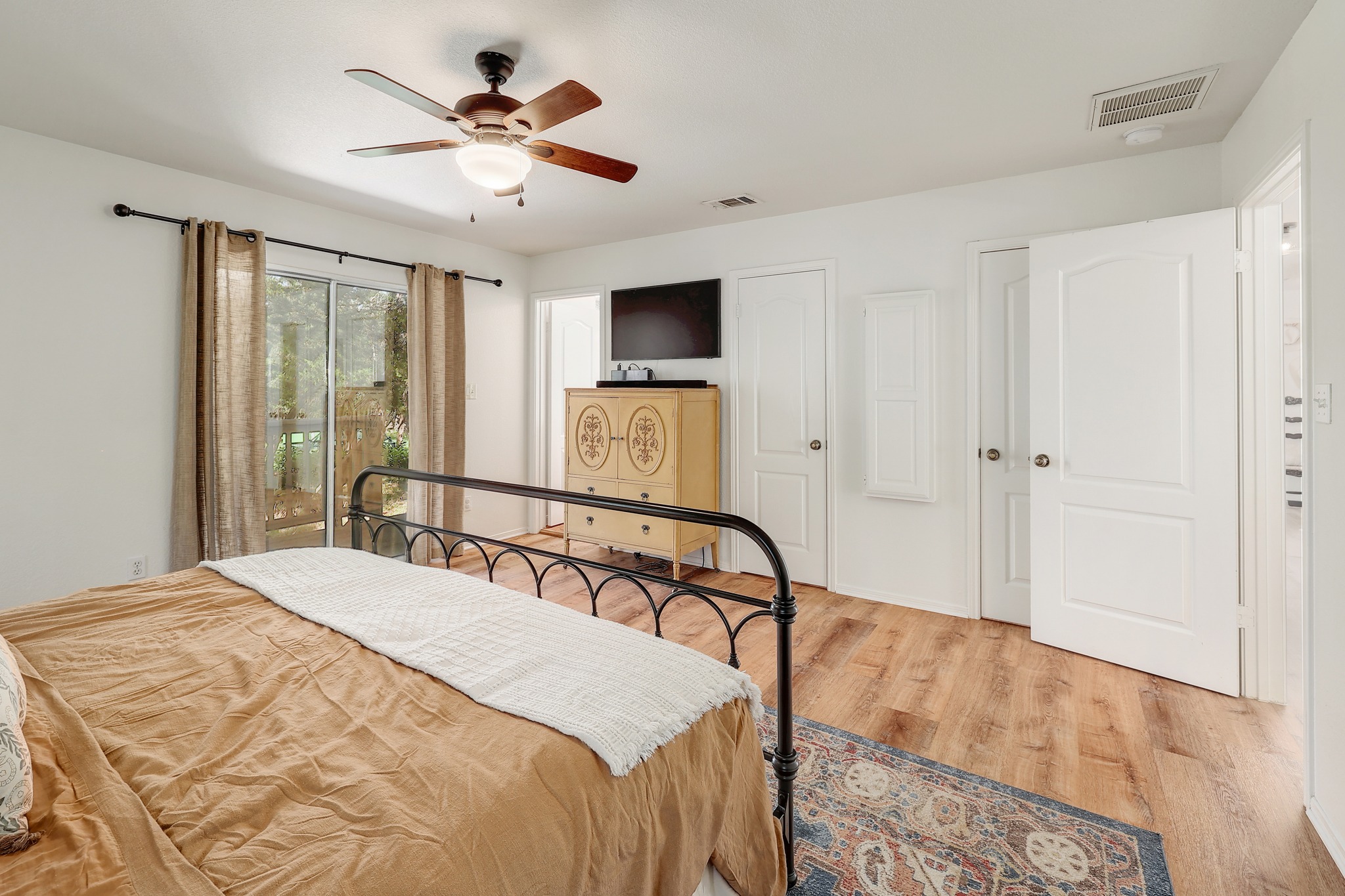 1455 County Road 262 Georgetown, TX 78633 - Photo 16 of 40 a bedroom with a bed and a chandelier