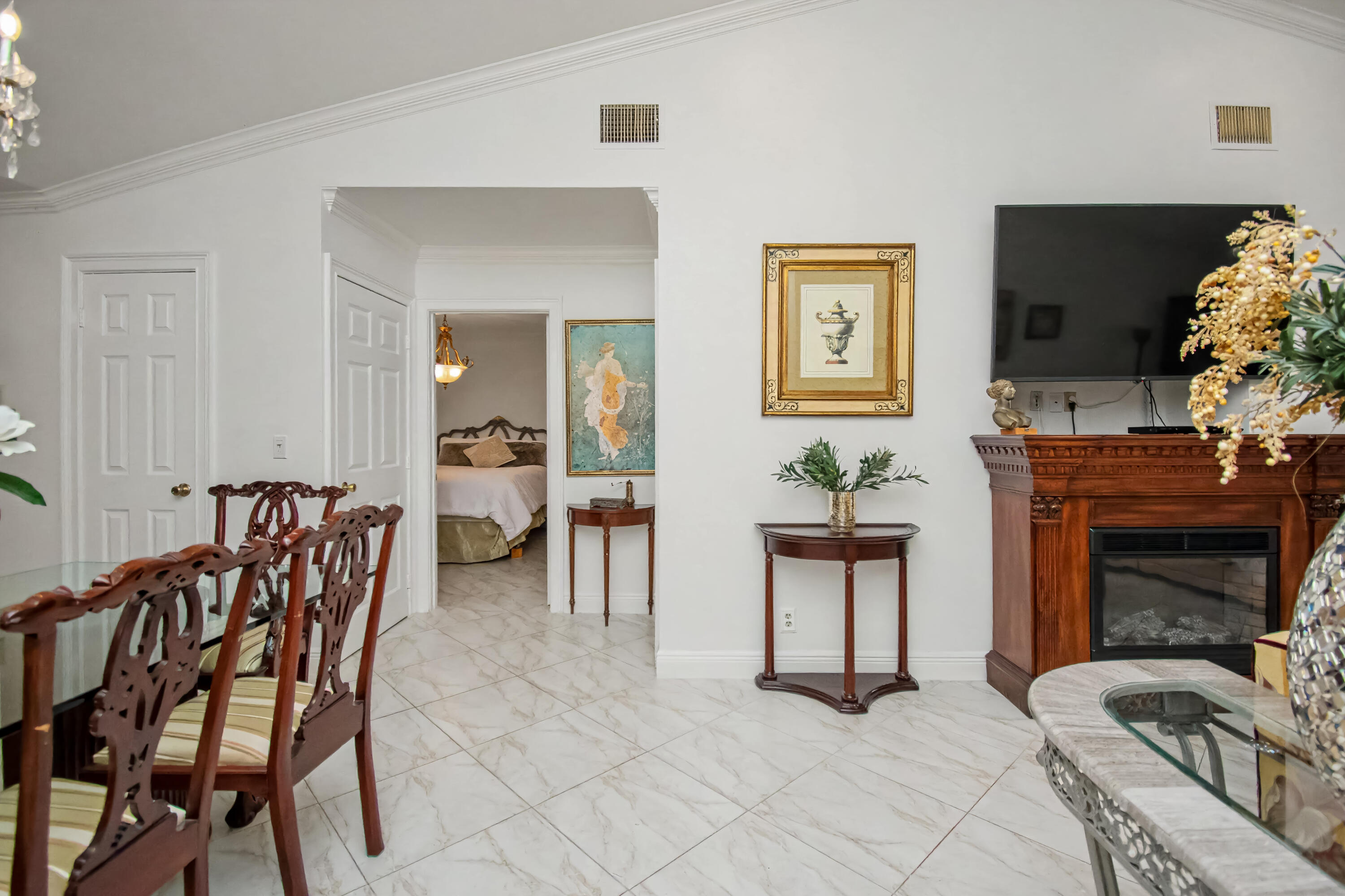 9708 Erica Court Boca Raton, FL 33496 - Photo 9 of 54 a bedroom with furniture and a fireplace