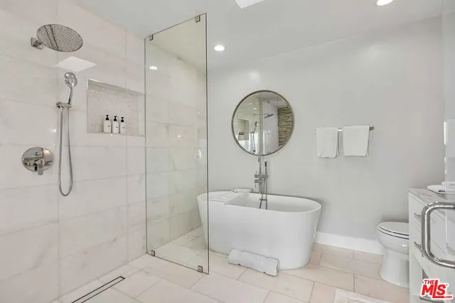 a bathroom with a toilet a sink and shower