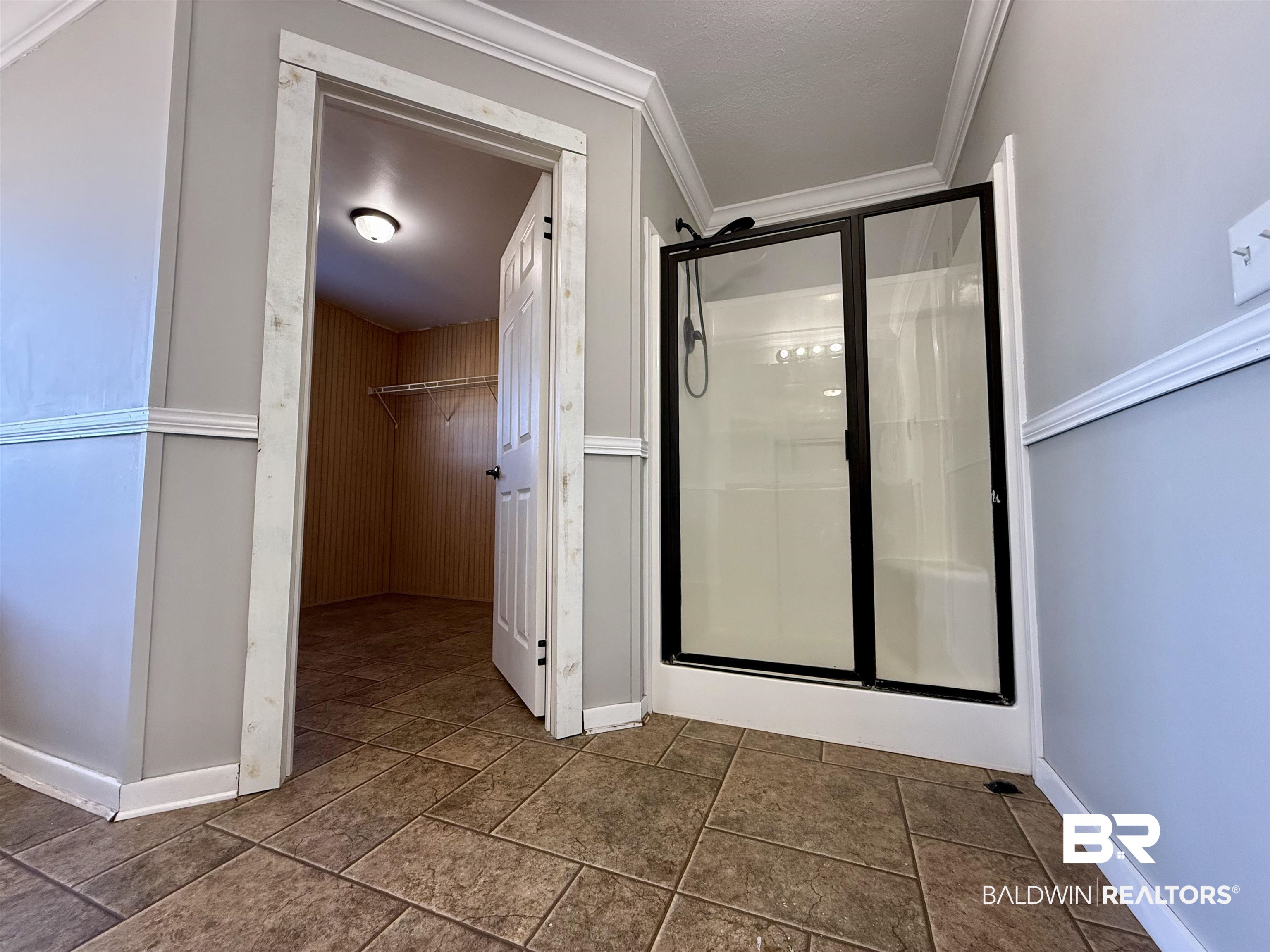 1064 Old Fannie Road Flomaton, AL 36441 - Photo 15 of 17 Bathroom featuring a shower stall, a spacious closet, and crown molding