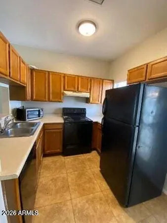a kitchen with a sink stove and microwave