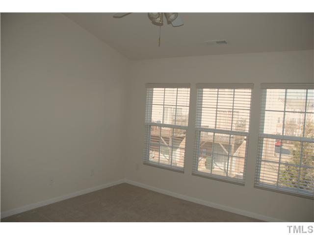 1711 Grace Brook Road Raleigh, NC 27609 - Photo 5 of 12 a view of an empty room with a window