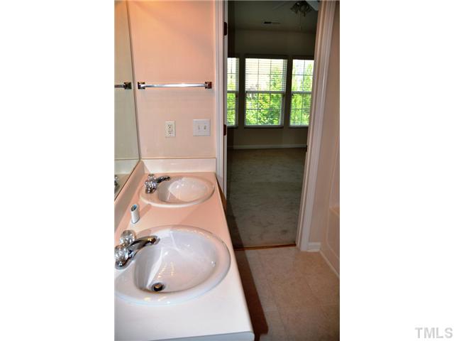1711 Grace Brook Road Raleigh, NC 27609 - Photo 7 of 12 a bathroom with a sink and mirror