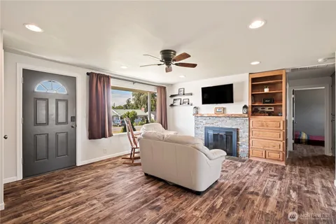 a living room with furniture a fireplace and a flat screen tv