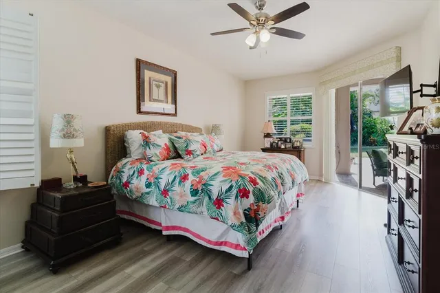 a bedroom with a bed couch and windows