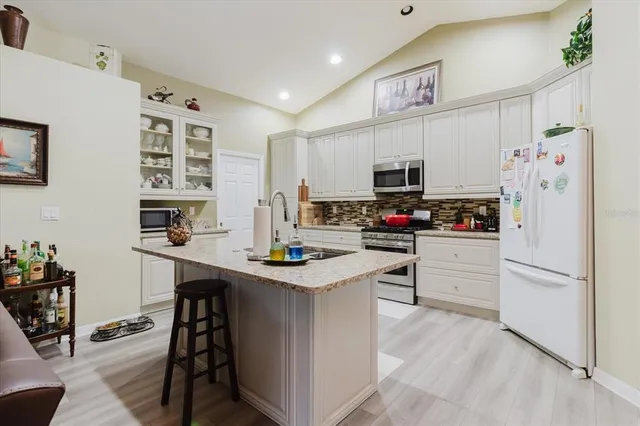 a kitchen with stainless steel appliances a stove refrigerator sink and microwave